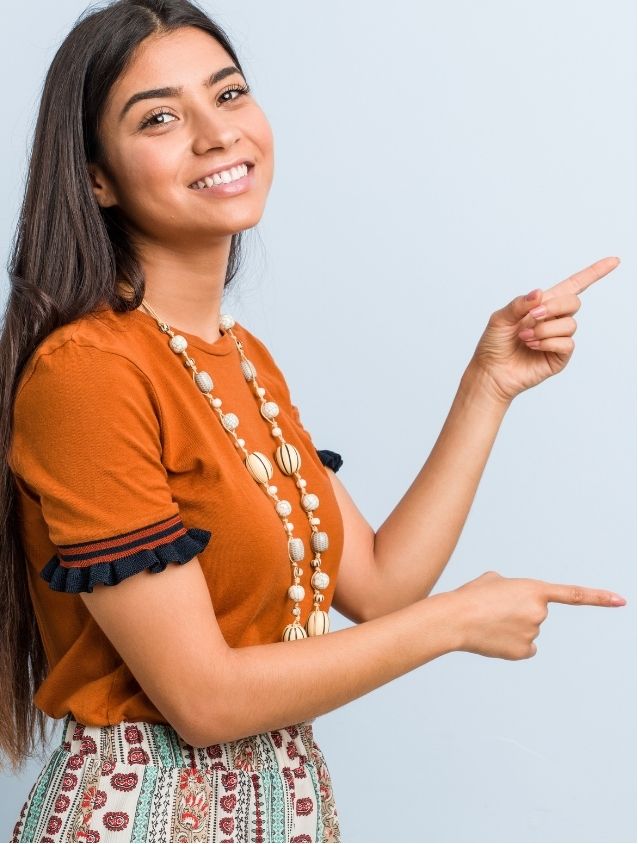 Woman in orange top pointing